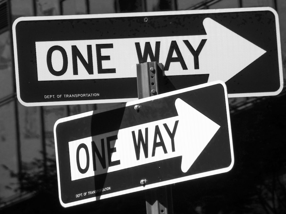 white and black pedestrian lane sign