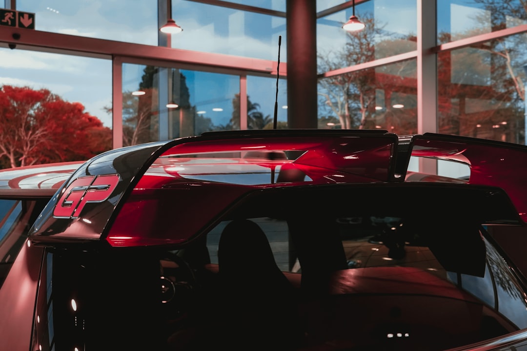 red ferrari car in a parking lot