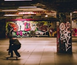 Colorful graffiti art on skatepark walls with skaters in the background