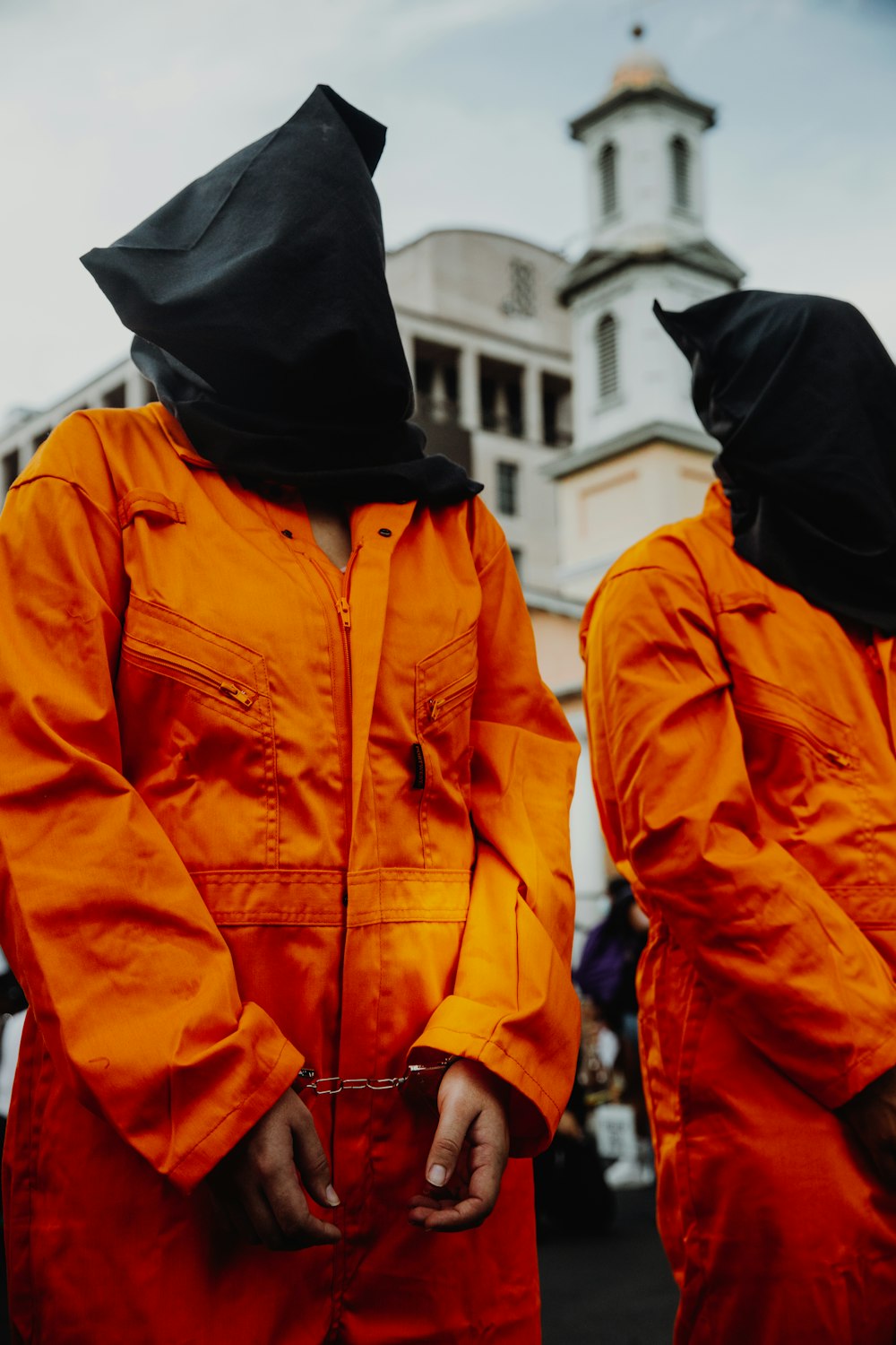 person in orange zip up jacket and black knit cap