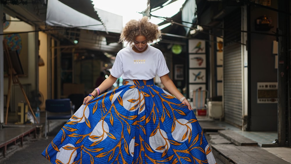 woman in white crew neck t-shirt and blue and yellow skirt