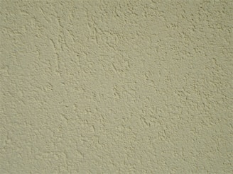 Close-up of textured wall finish being applied with a trowel in a cozy home.