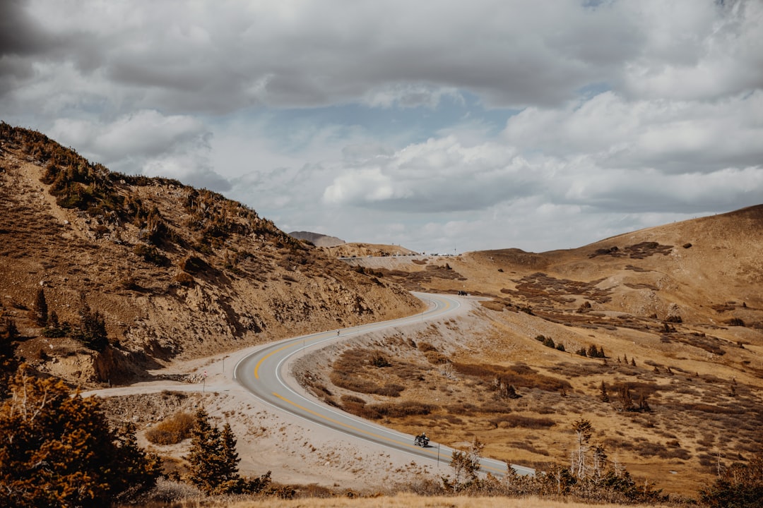 road in the middle of brown mountains