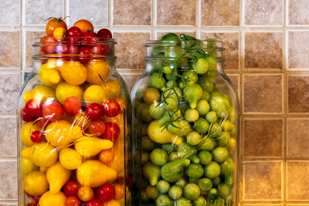 green and red fruit in glass jar