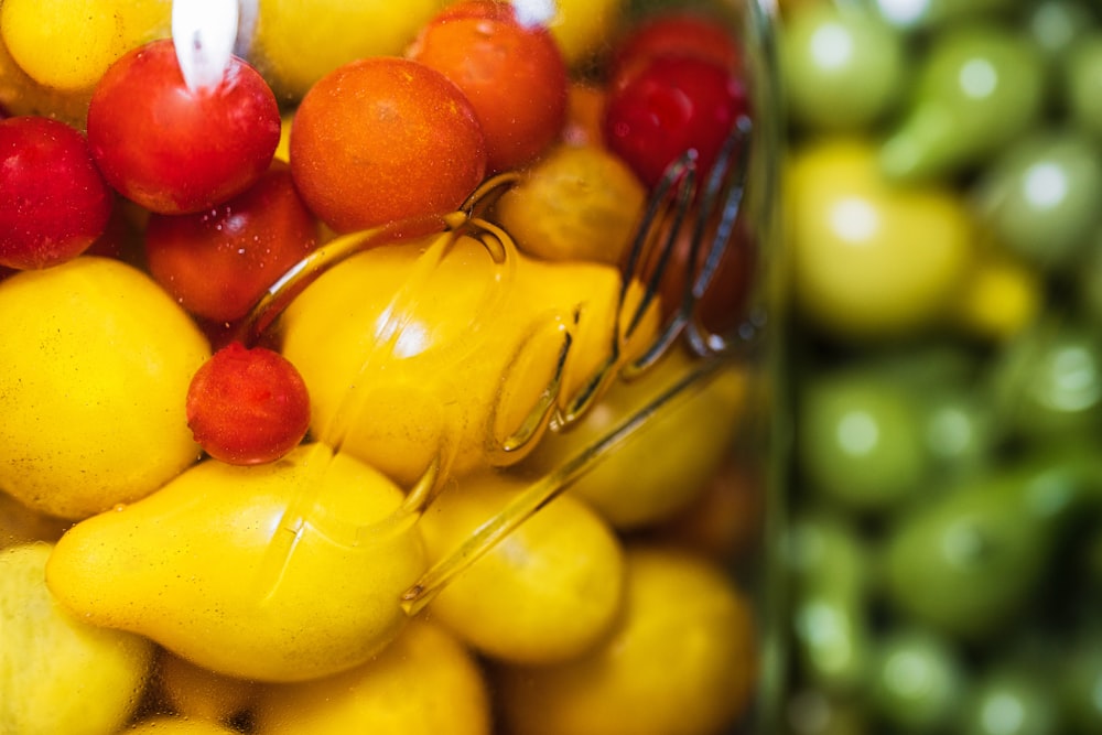 yellow and red round fruits