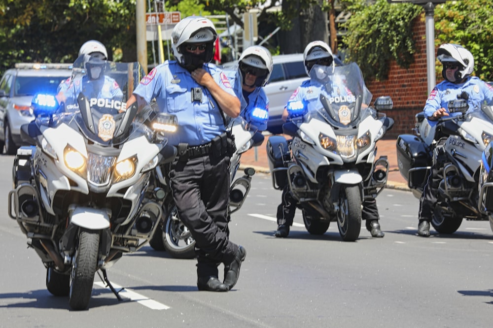 昼間にバイクに乗る青と白のオートバイスーツを着た男性