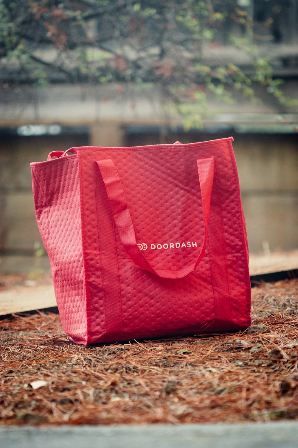 a red shopping bag sitting on the ground