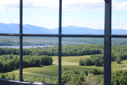 A panoramic view of a sky glass bridge stretching over a scenic mountainous landscape.