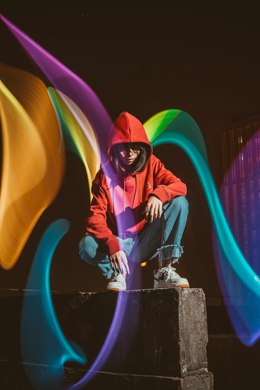 man in blue jacket and pants sitting on concrete bench