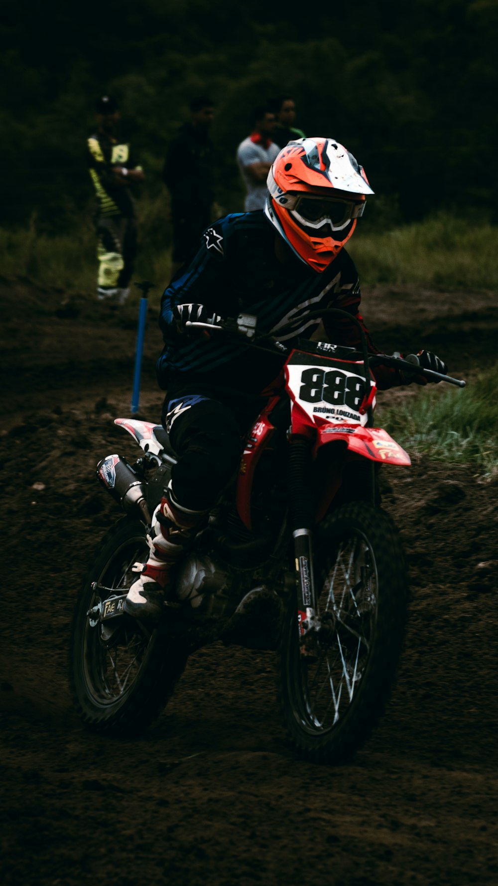 man in black and red motocross helmet riding motocross dirt bike