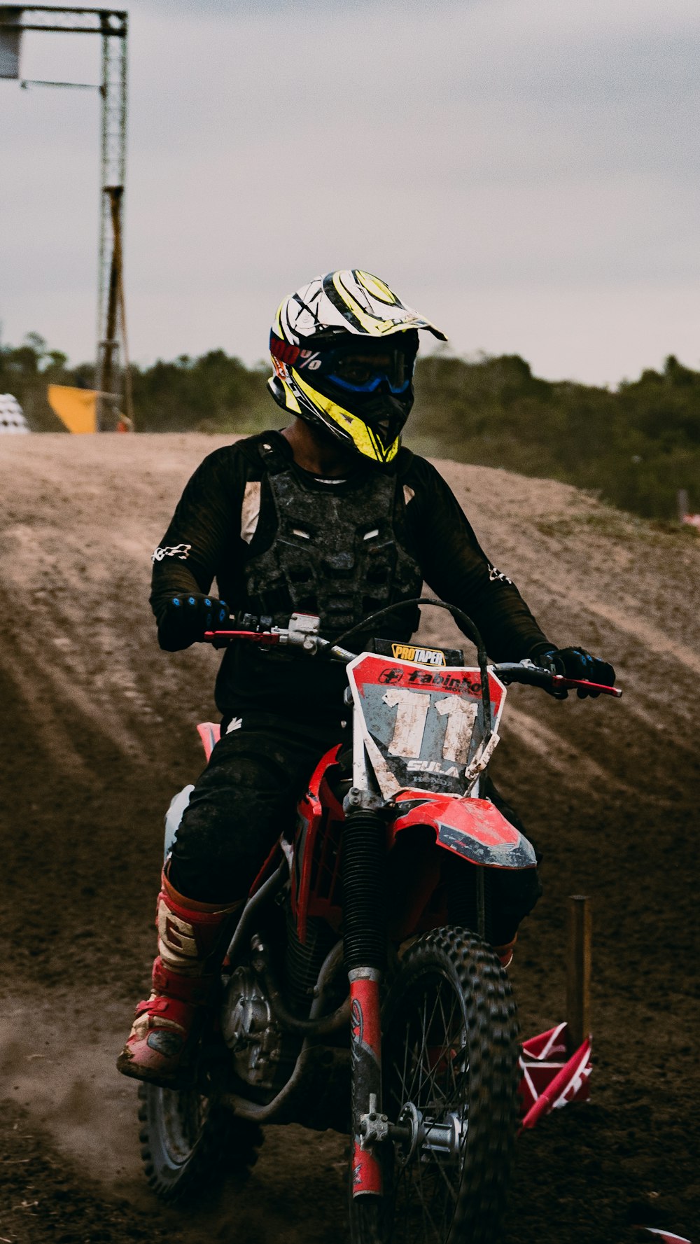 man in black jacket riding motocross dirt bike