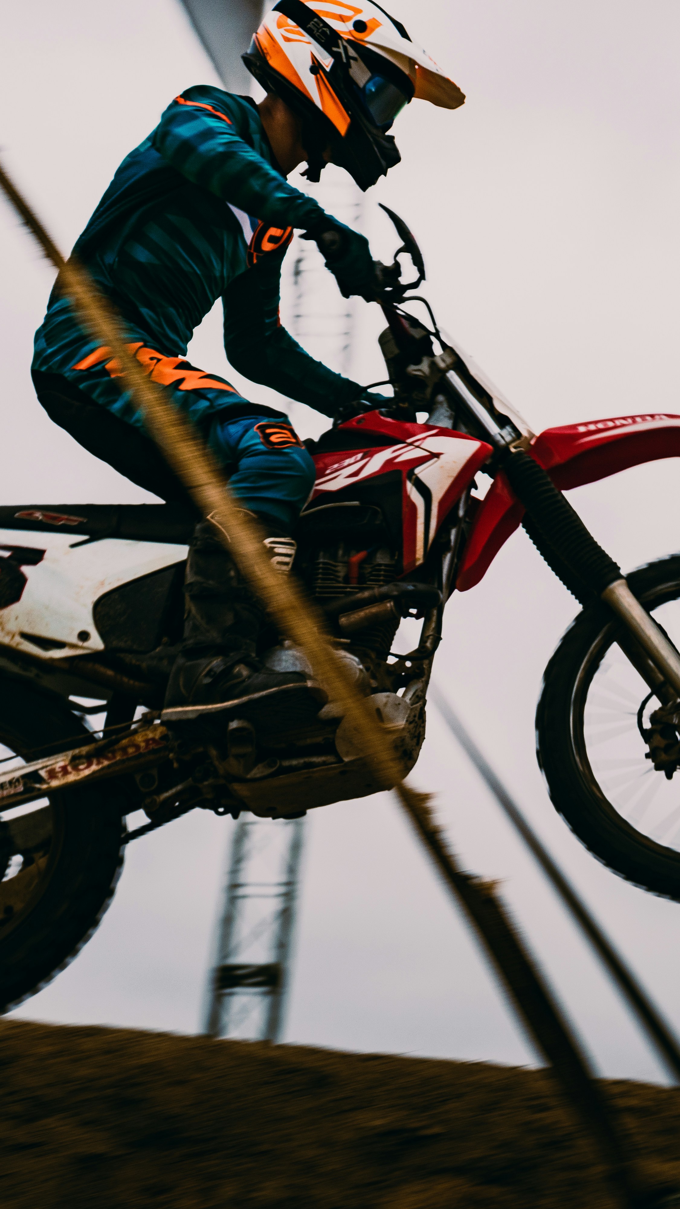 man in blue jacket riding red and black honda motorcycle photo 
