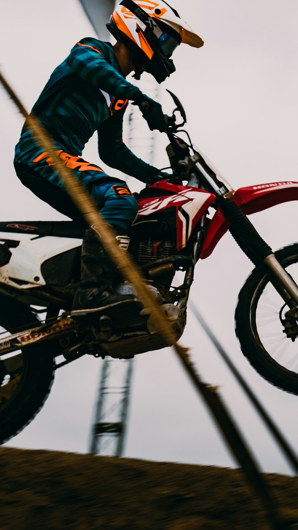 man in blue jacket riding red and black honda motorcycle