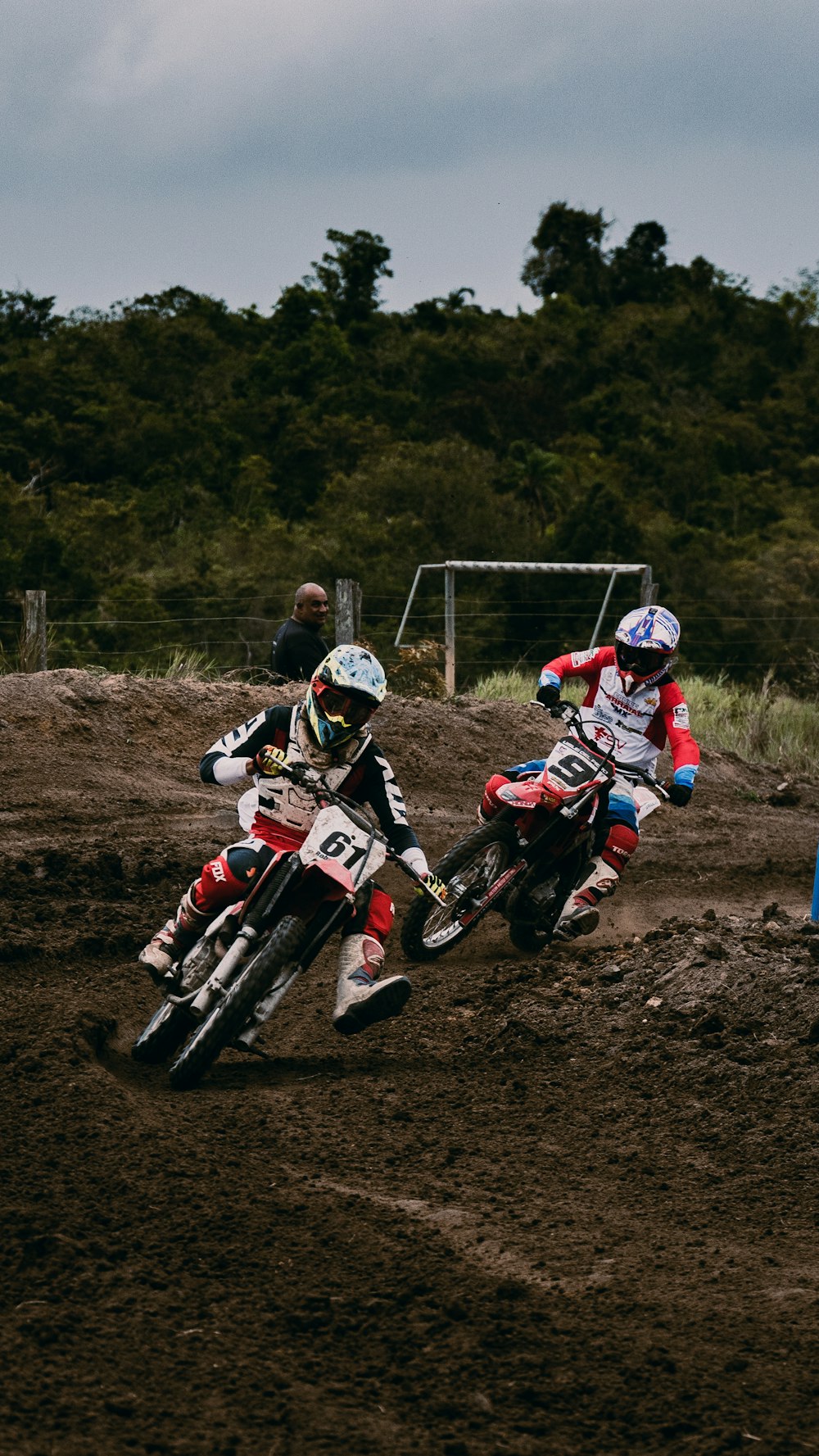 man in red and white motocross suit riding motocross dirt bike