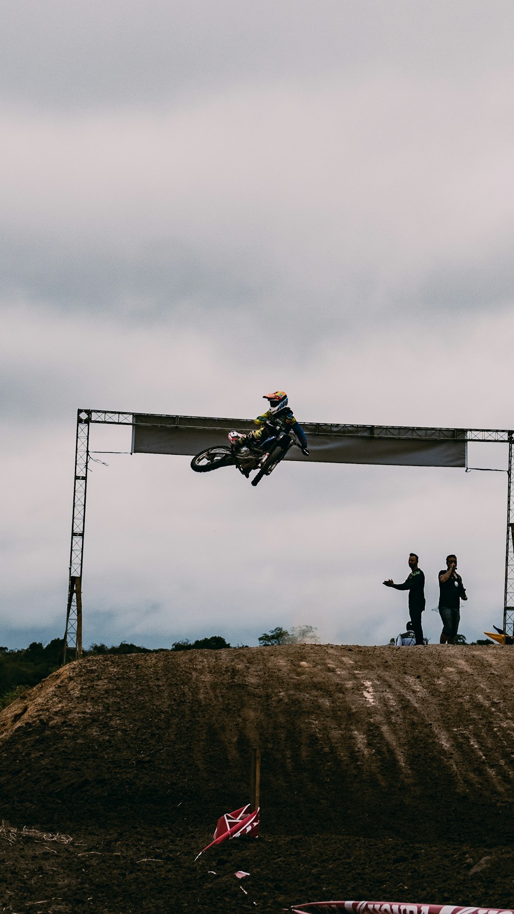 man in black jacket and black pants with black and orange helmet riding black and yellow