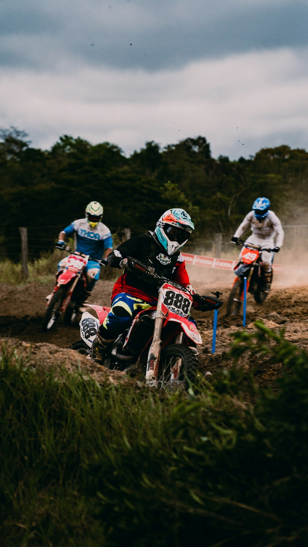 people riding on motocross dirt bikes during daytime