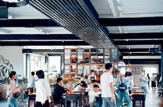 A warm Scandinavian-style cafe scene with natural light illuminating fresh produce and behind-the-scenes team members planning content.