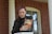 woman in black coat holding book