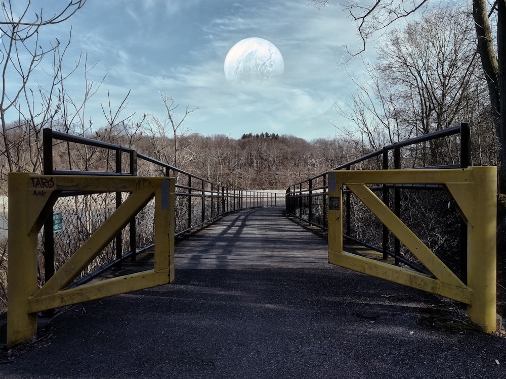 brown wooden bridge under blue sky during daytime