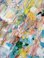 Close-up of a vibrant abstract painting with bold brushstrokes and rich colors.