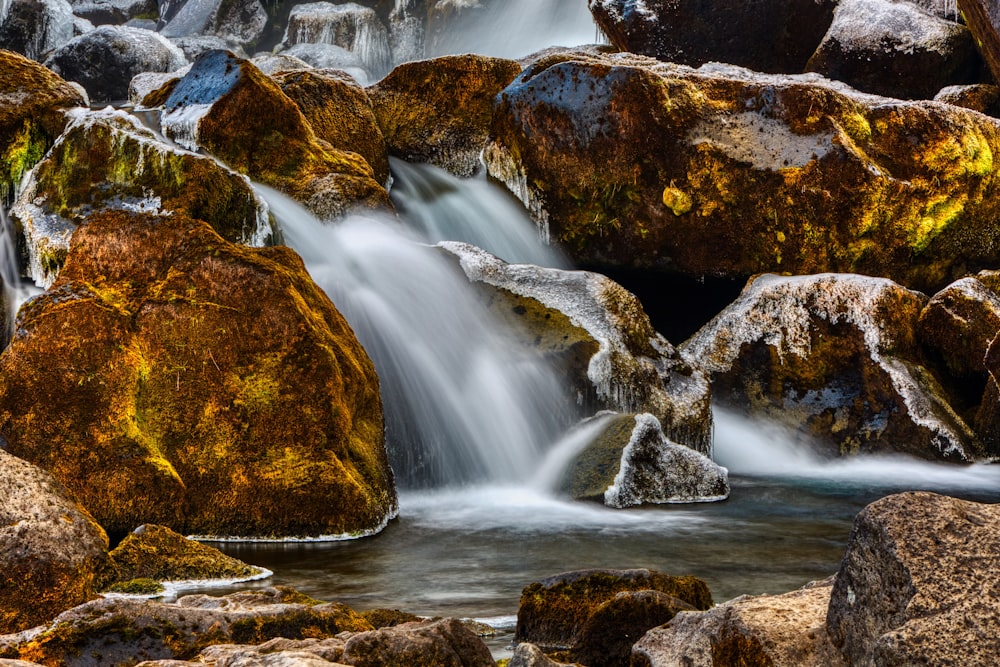 brown rock formation with water falls