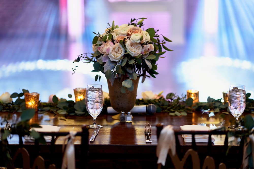 white flowers in clear glass vase on brown wooden table