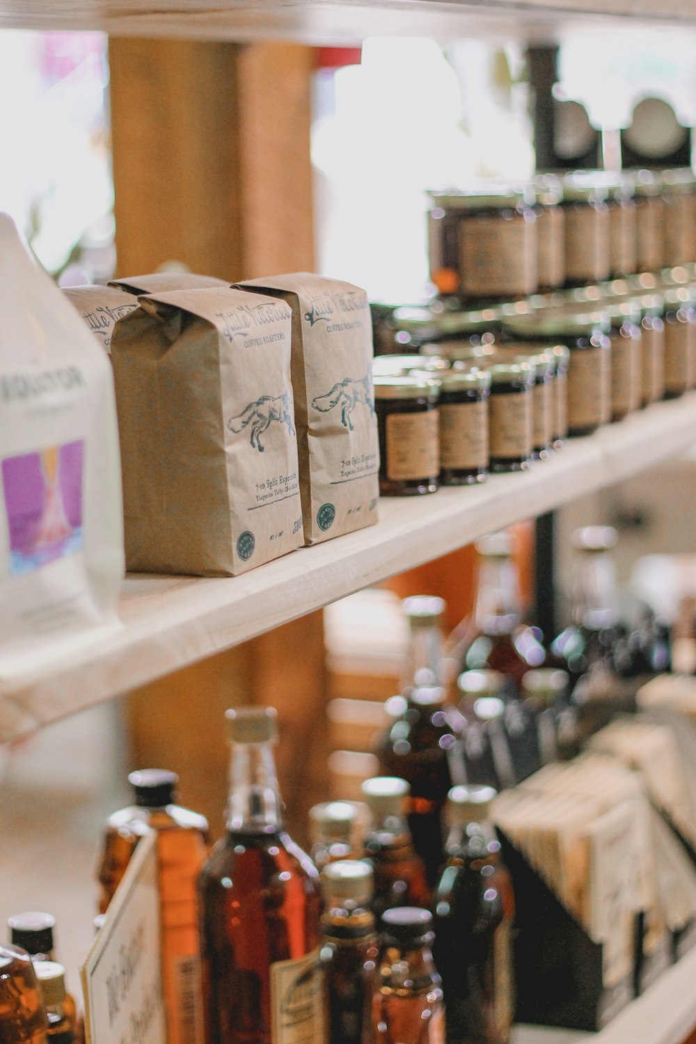 brown cardboard boxes on brown wooden shelf