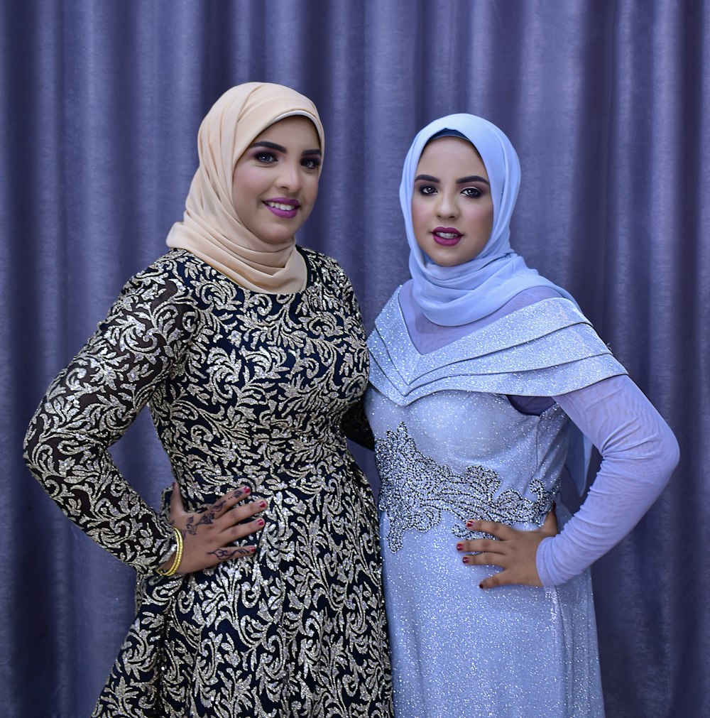 woman in white hijab and black and white floral long sleeve dress