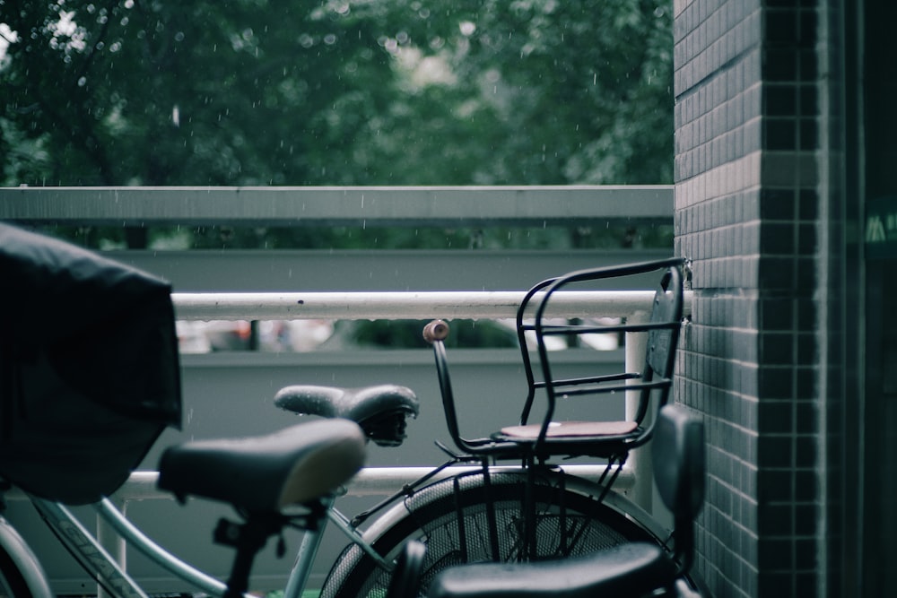 black city bike parked beside black metal fence