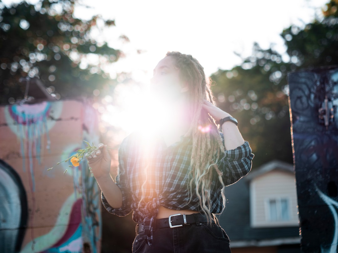 woman in black leather jacket holding her hair