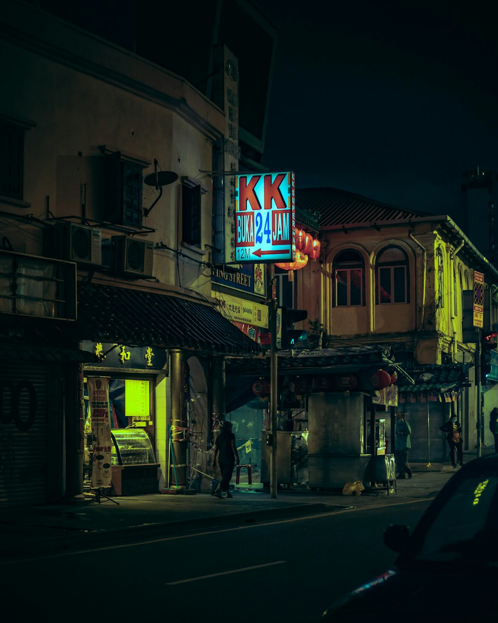 cars parked in front of store during night time