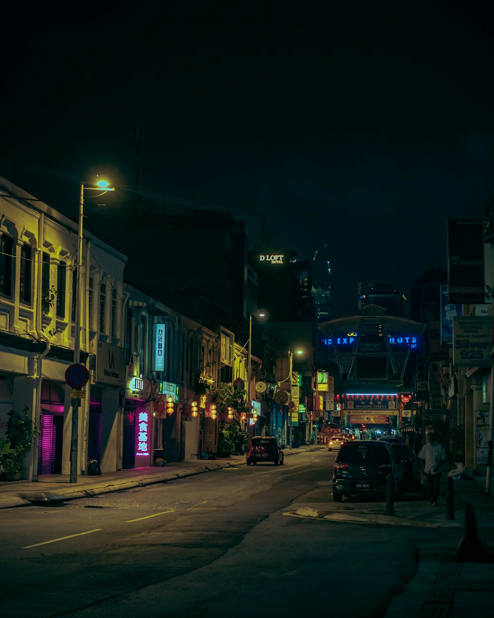 cars parked on side of the road during night time