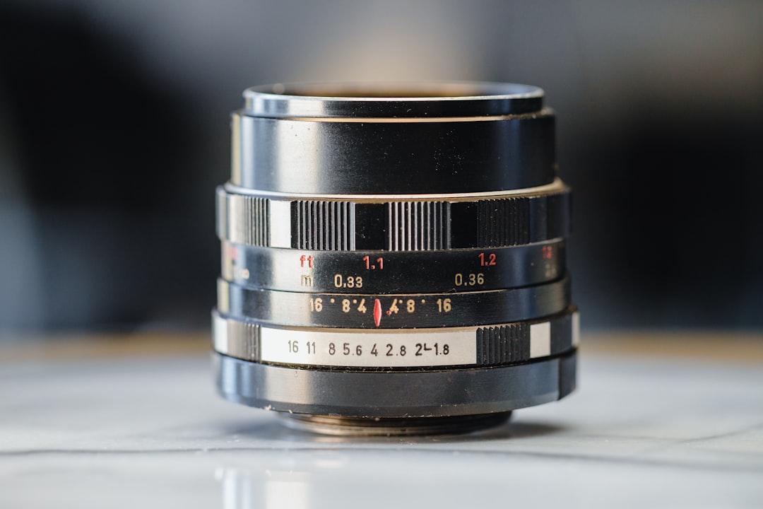 black camera lens on white table