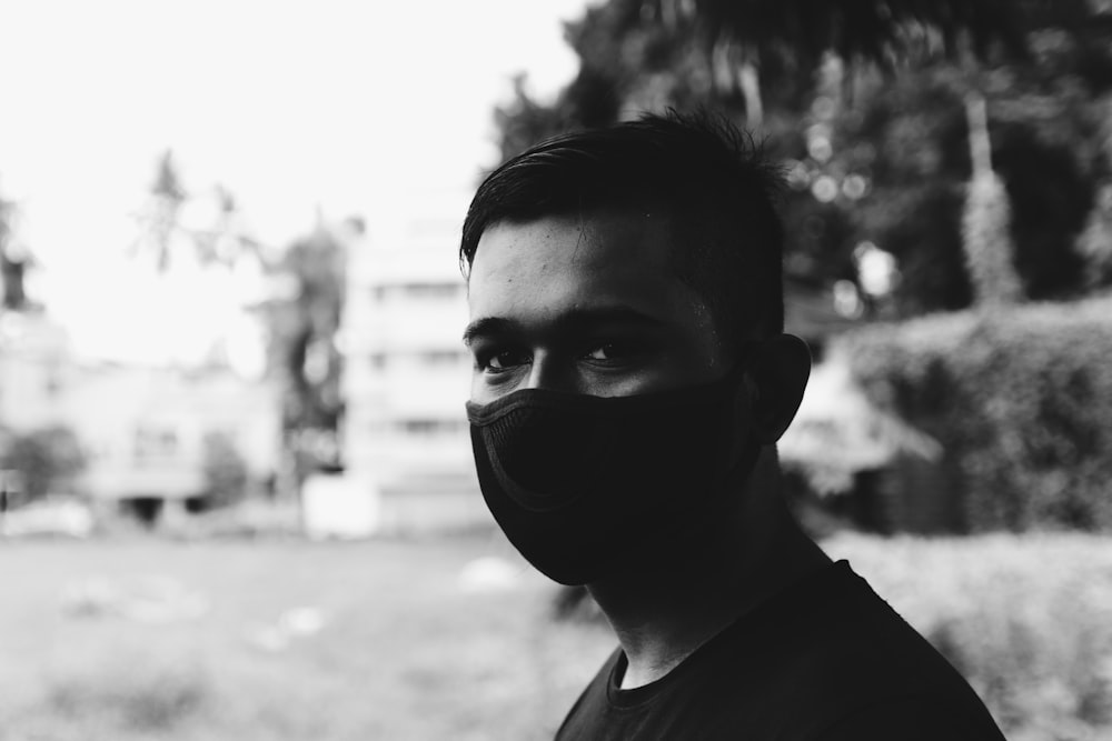 grayscale photo of man wearing black mask