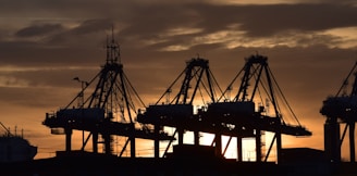 silhouette of cargo ship during sunset