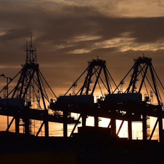 silhouette of cargo ship during sunset