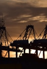 silhouette of cargo ship during sunset