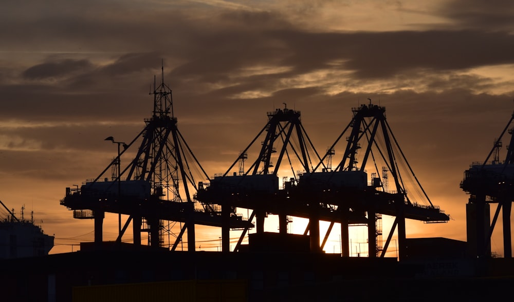 silhouette of cargo ship during sunset