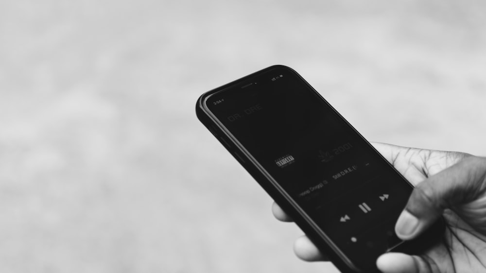 person holding black iphone 4