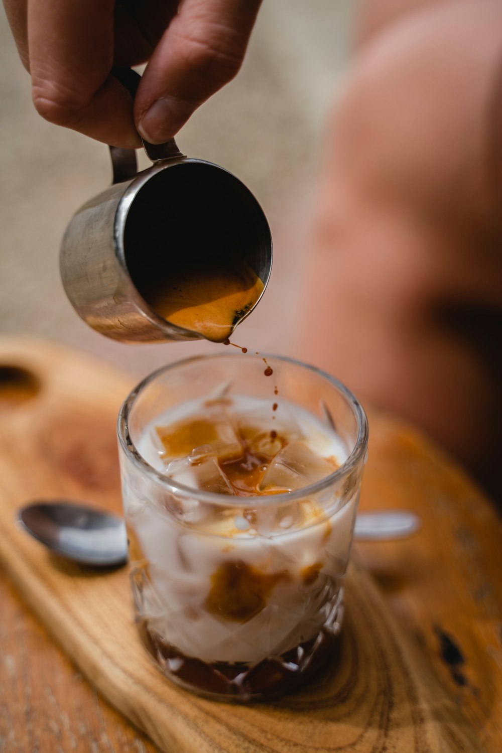 a person is pouring something into a glass