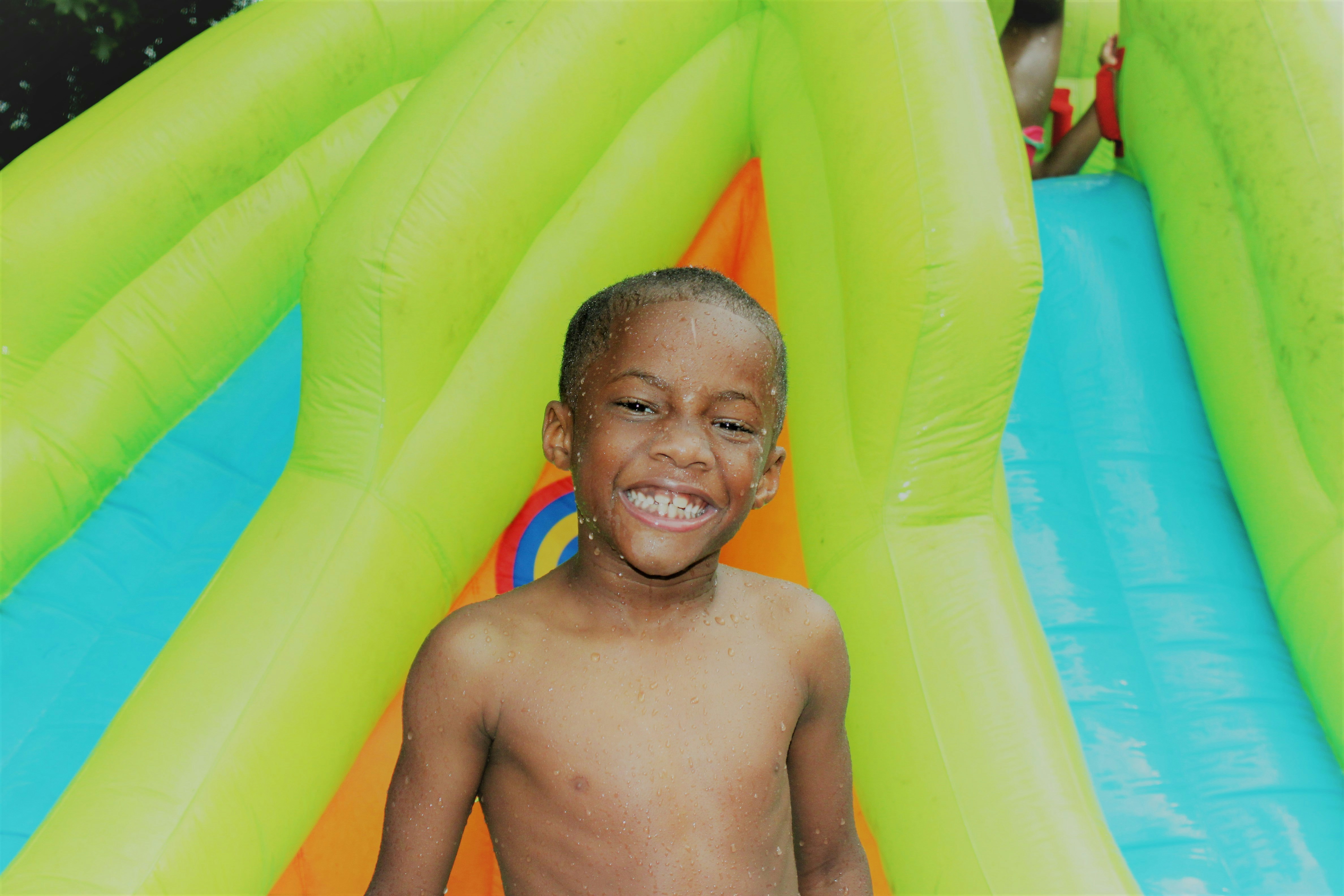 topless boy standing on inflatable ring