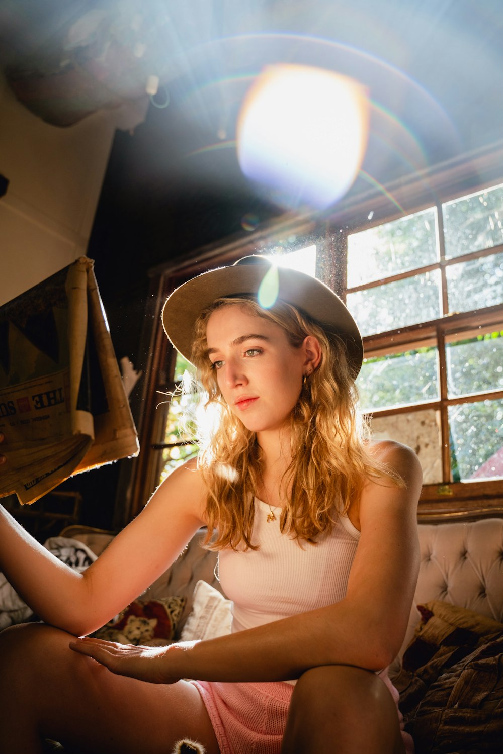 woman in white tank top wearing black hat