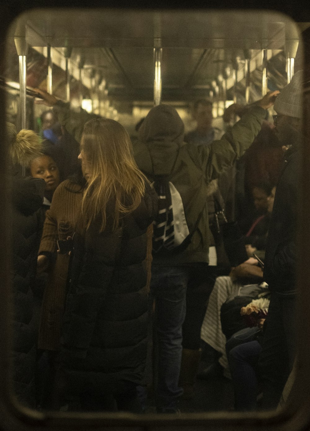 woman in black jacket standing in front of people