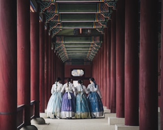 man and woman in white and blue dress walking on hallway