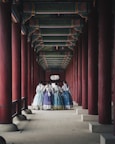 man and woman in white and blue dress walking on hallway