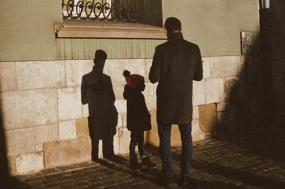 man in black coat standing beside man in black coat