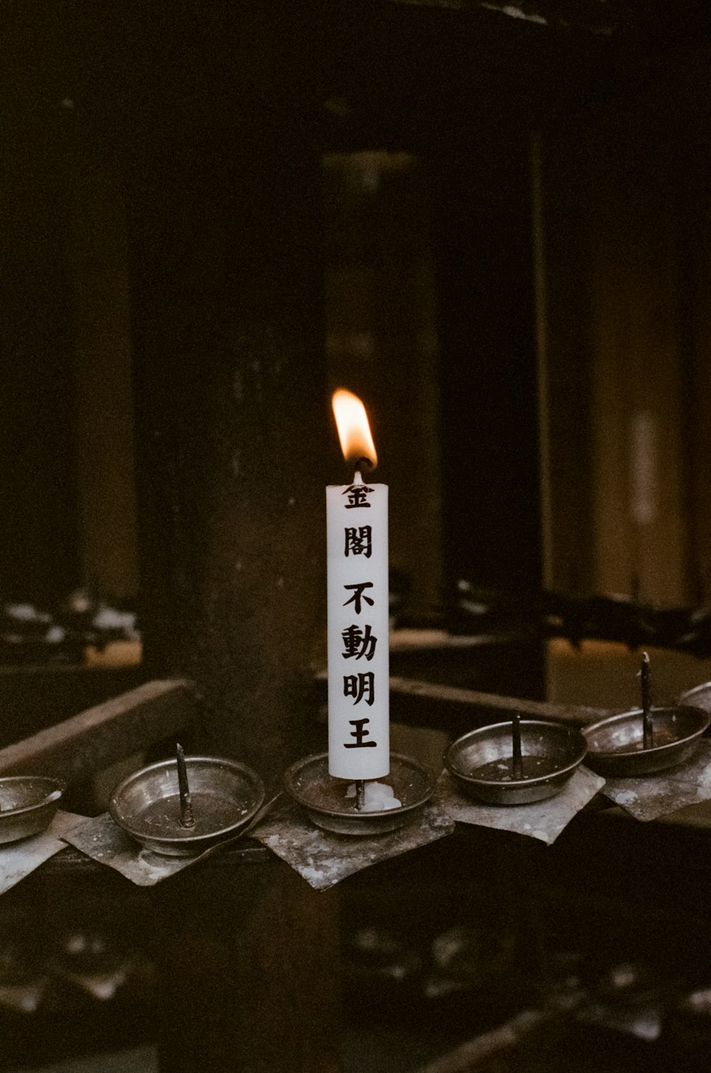 white and black candle on silver round tray