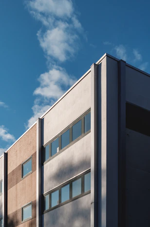 Sunlit modern commercial building showcasing clean lines and fresh construction materials.