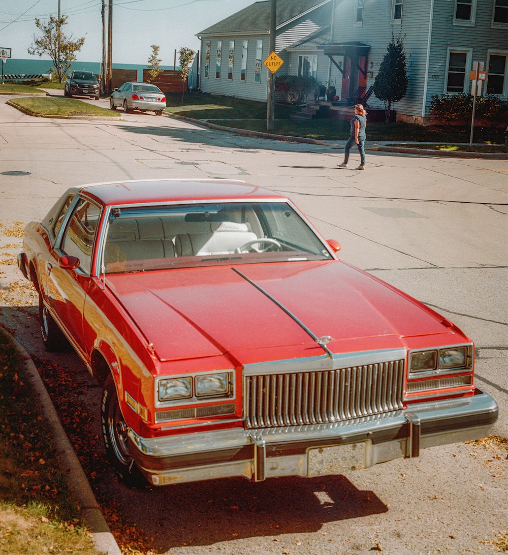 red and white classic car on road during daytime