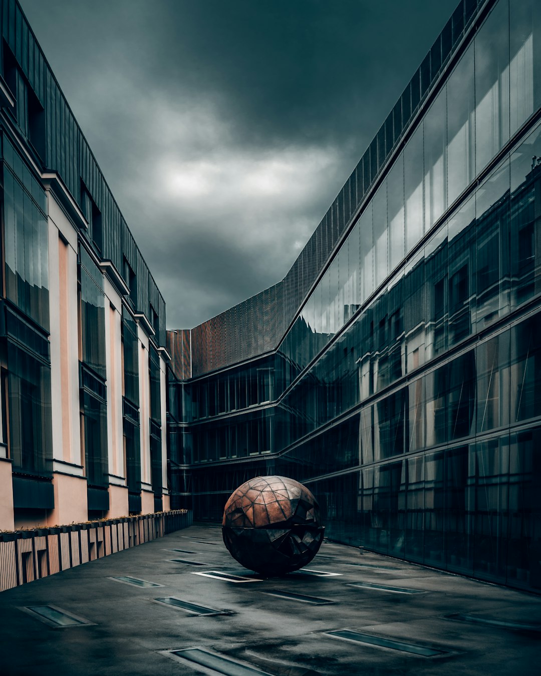 brown and black ball on gray concrete floor near brown concrete building during daytime